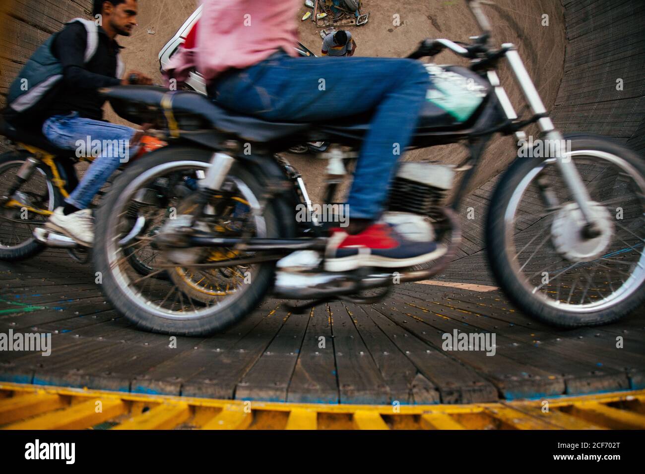 Man Riding Engine Men riding motorbikes round wall hi-res stock photography and images ...