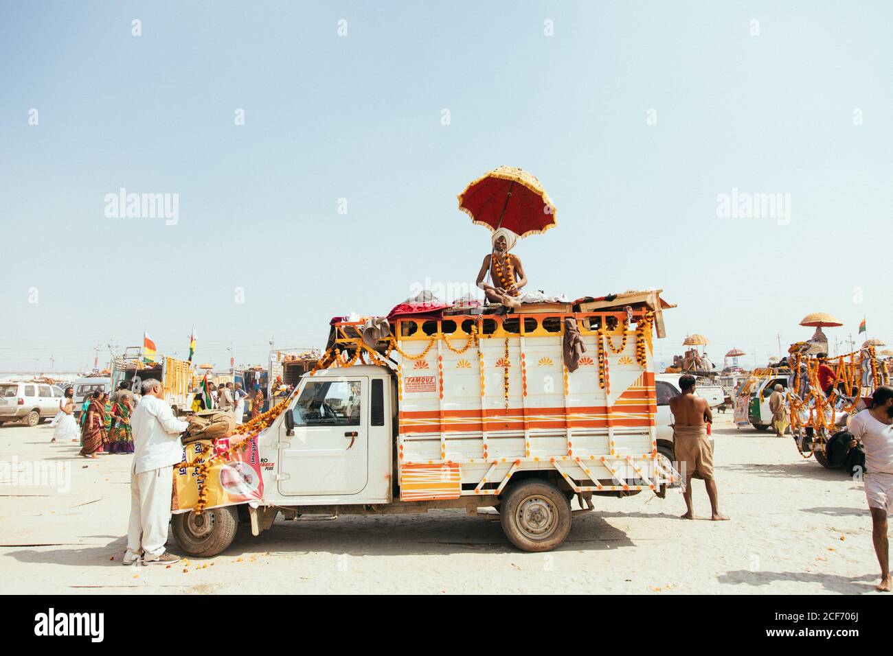 Allahabad, India - February, 2018: mature old men in turbans sitting of top of old shabby lorry and looking at camera on street in Prayag Kumbh Mela Festival Stock Photo