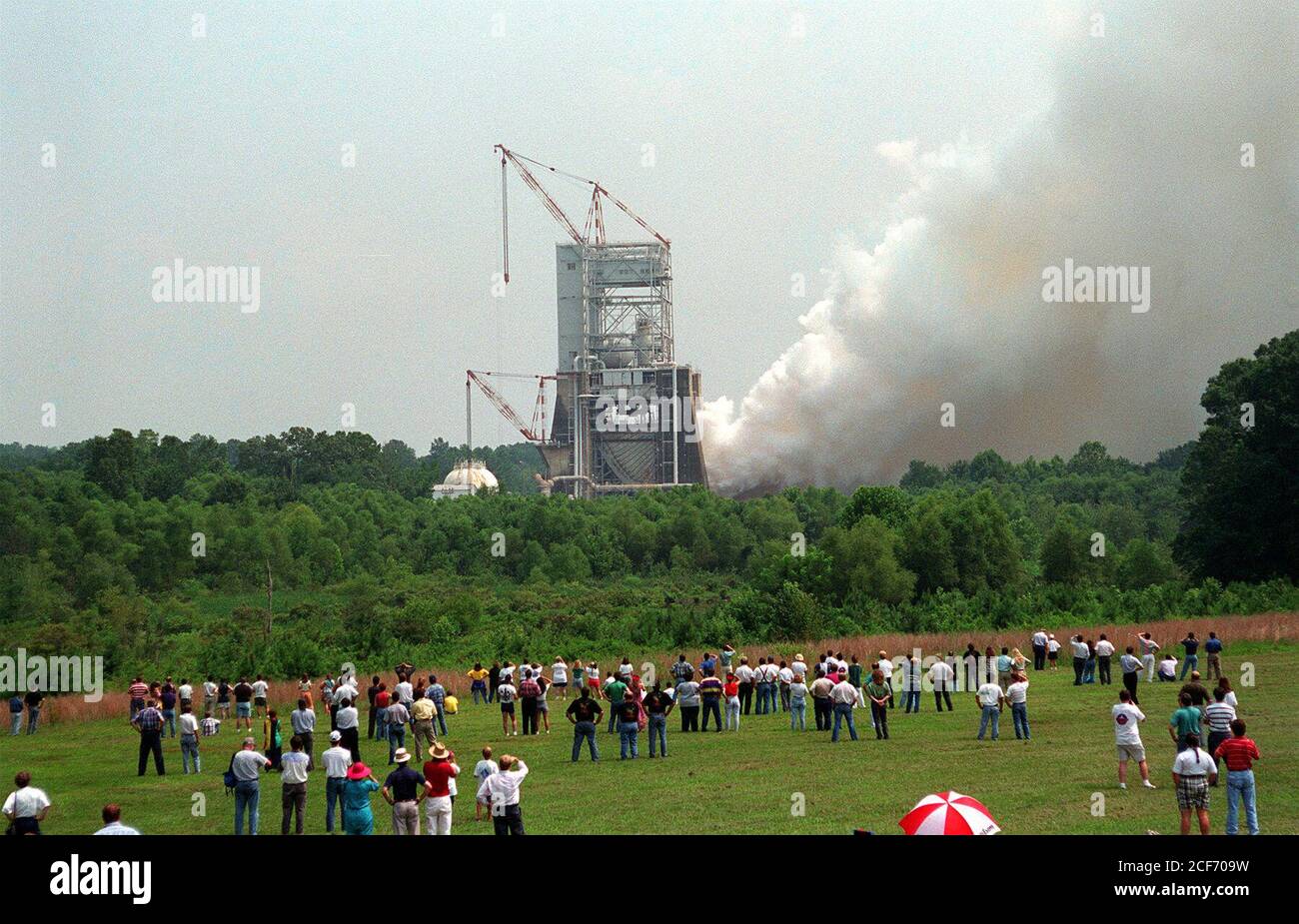 On the 25th Anniversary of the Apollo 11 (the first moon landing mission) launch, Marshall Space & Flight Center celebrated with a test firing of the Space Shuttle Main Engine (SSME) at the Technology Test Bed (TTB). This drew a large crowd who stood in the fields around the test site and watched as plumes of white smoke verified ignition. Stock Photo