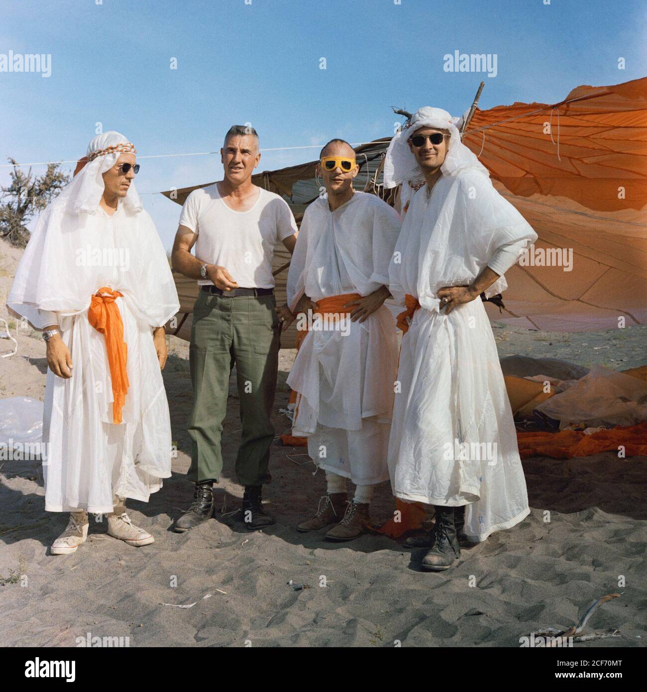 Three astronauts participating in Apollo desert survival training in Washington state pose with Air Force Col. Chester Bohart (second from right). Standing from left to right are Charles M. Duke, Jr., Thomas K Mattingly, Col. Bohart, and John L. Swigert. Since the Mercury Program, astronauts have taken survival courses in case they are forced to land on a remote part of the Earth where they may need to do without human help for several weeks Stock Photo