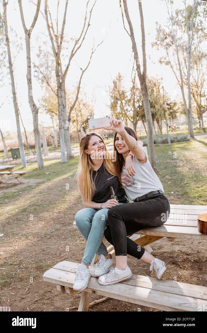 Smiling women taking selfie in park Stock Photo