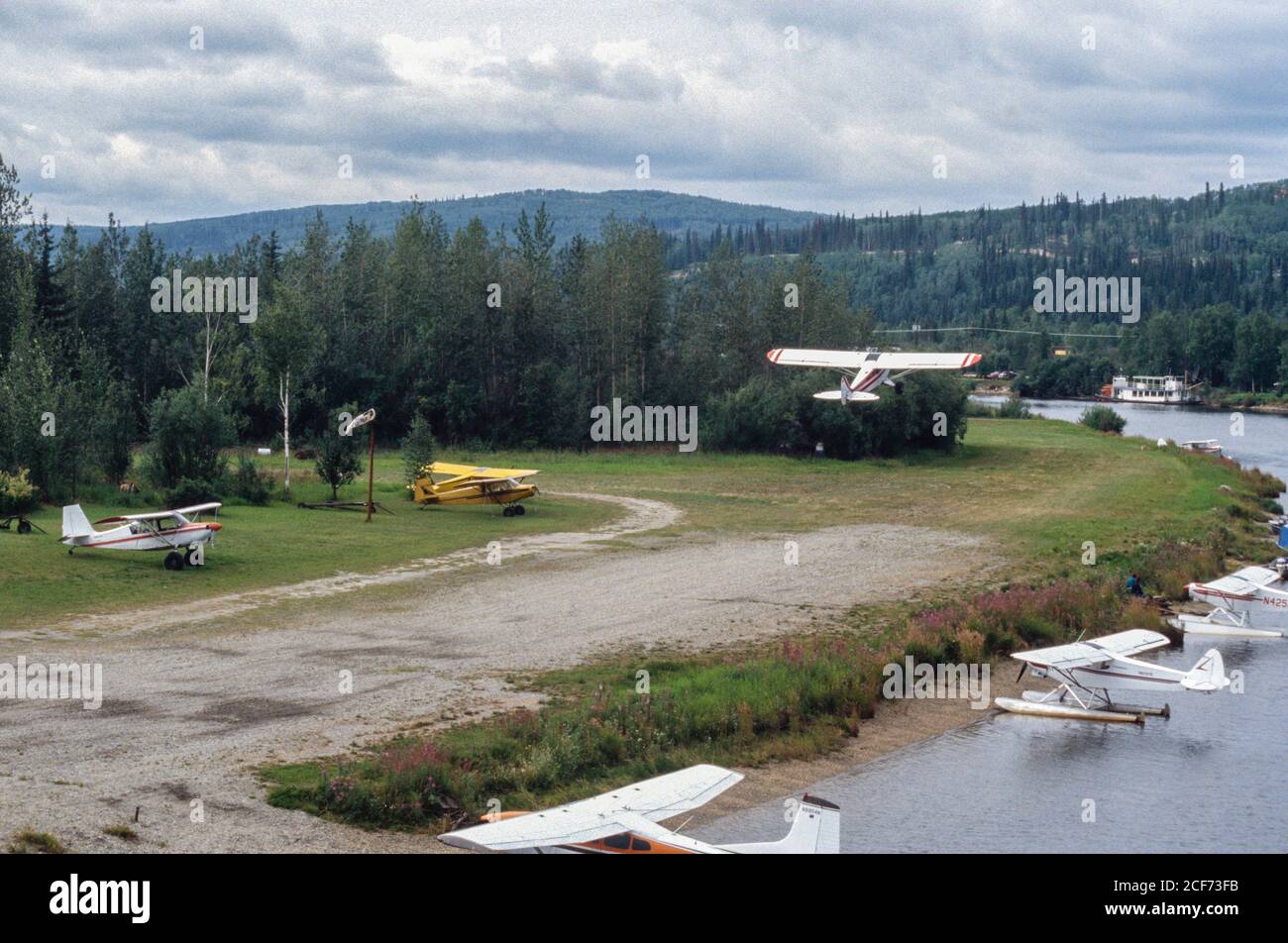 Fairbanks, Alaska, Tanana River.  Airplanes in your Front Yard: one taking off.  Seaplanes in the Tanana River. Stock Photo