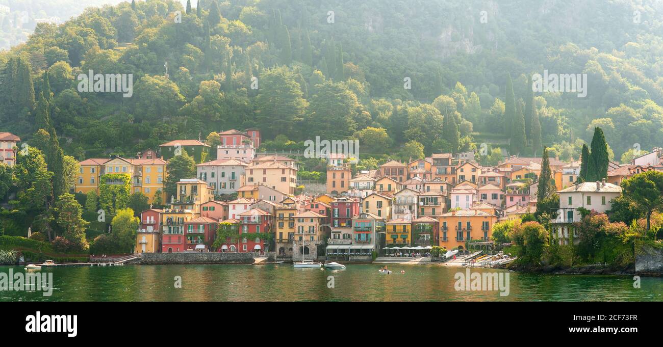Panorama of Morning View on Colorful Town Varenna on Lake Como in Italy. Bright Architecture with Yellow Buildings. Stock Photo