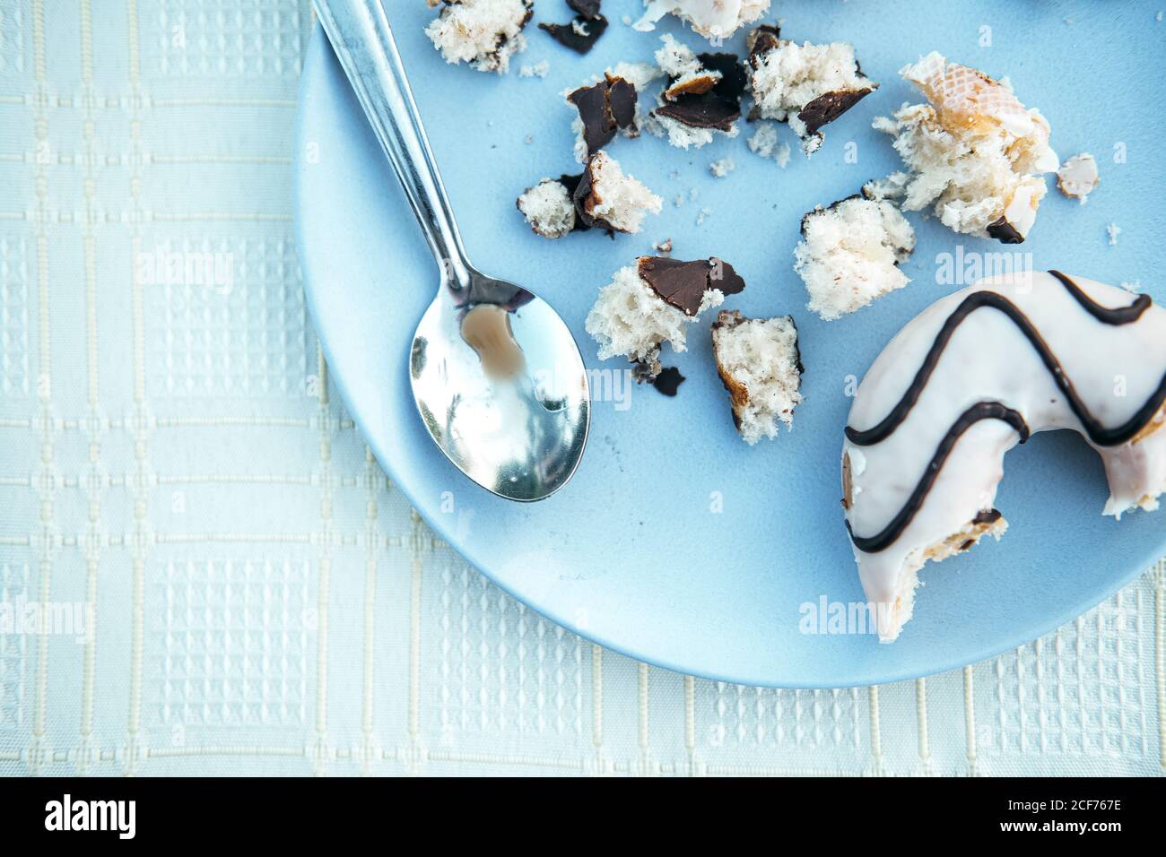 Donuts with icing and chocolate on plate Stock Photo