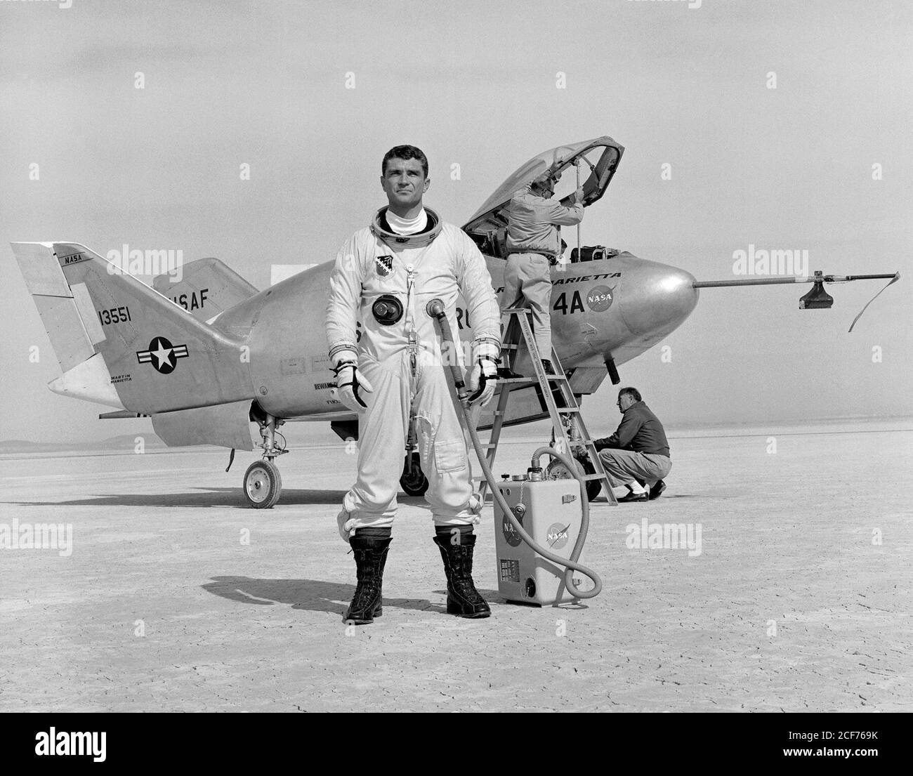 Air Force pilot Major Cecil Powell stands in front of the X-24A after a research flight. Built for the Air Force by Martin Marietta, the X-24A was a bulbous vehicle shaped like a tear drop, with three vertical fins at the rear for directional control. It weighed 6,270 pounds, was just over 24 feet long, and had a width of nearly 14 feet. The first unpowered glide flight of the X-24A was on April 17, 1969. The pilot was Air Force Major Jerauld Gentry. Gentry also piloted the vehicle on its first powered flight March 19, 1970. It was flown 28 times in a program which, like the HL-10, helped vali Stock Photo