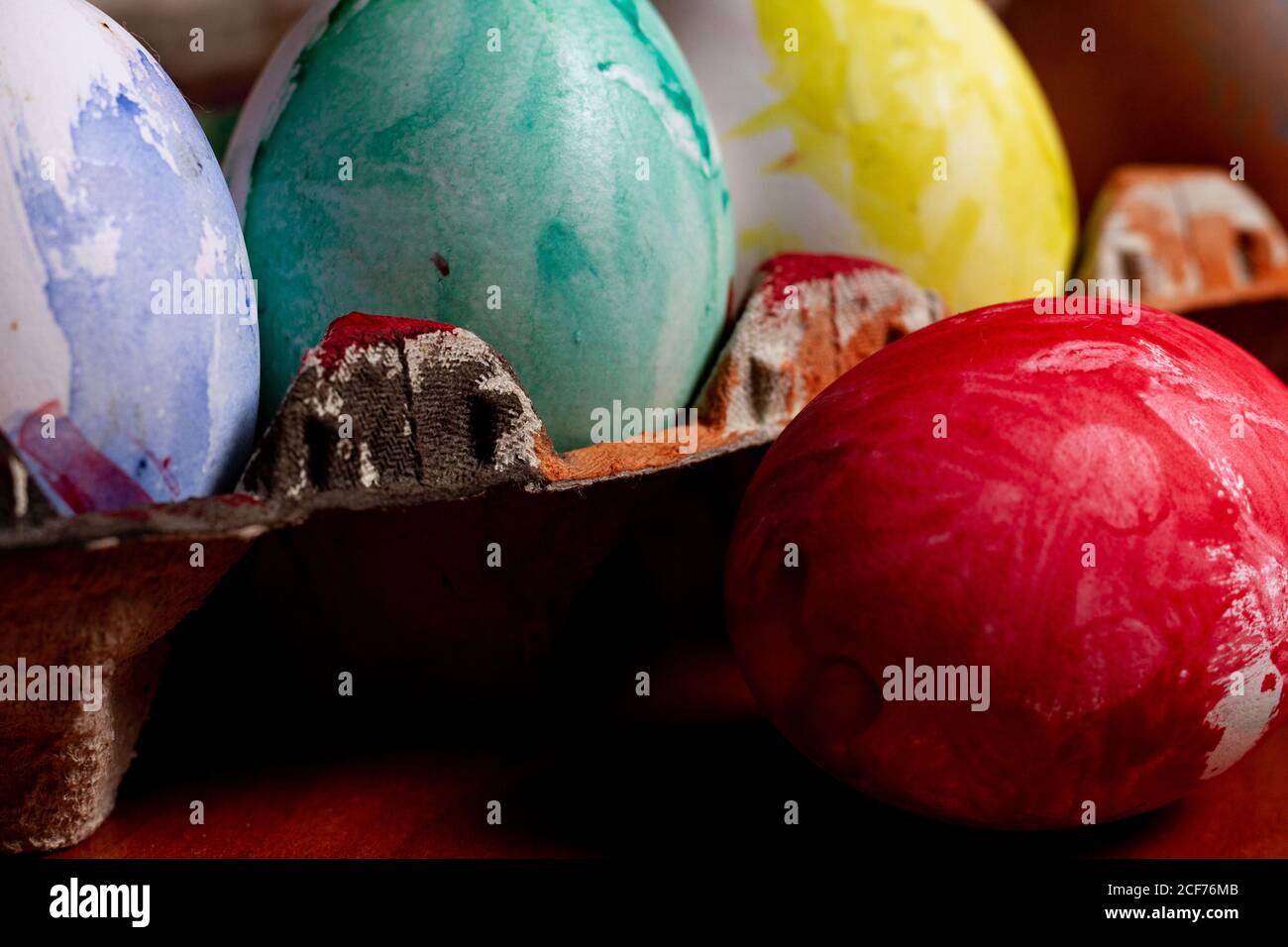 Set of painted Easter eggs in container on table Stock Photo