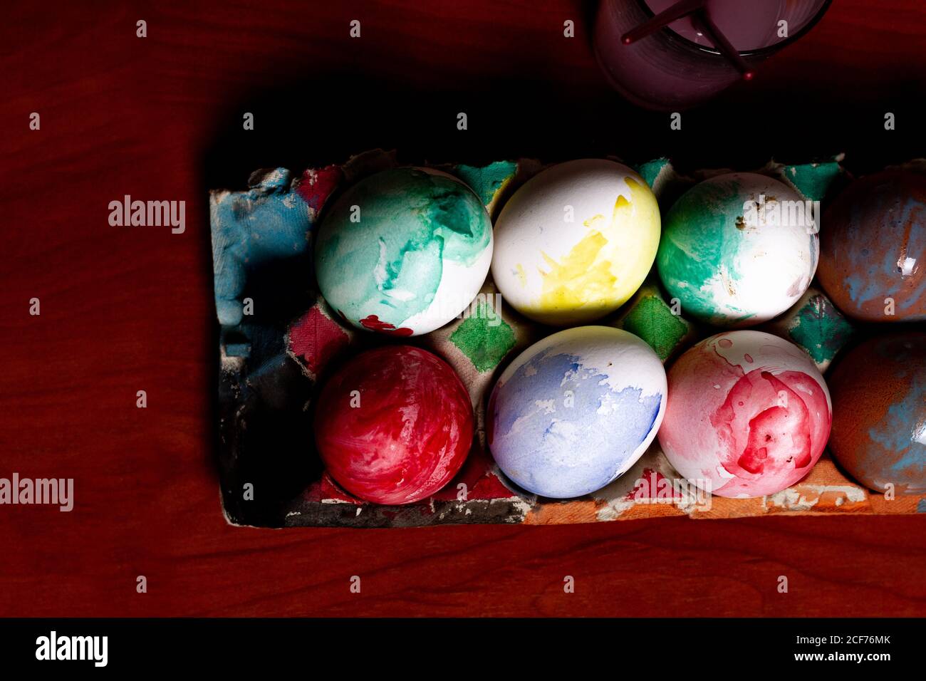 Set of painted Easter eggs in container on table Stock Photo