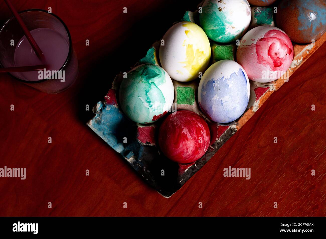 Set of painted Easter eggs in container on table Stock Photo
