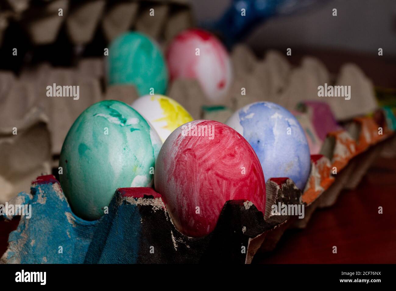 Set of painted Easter eggs in container on table Stock Photo