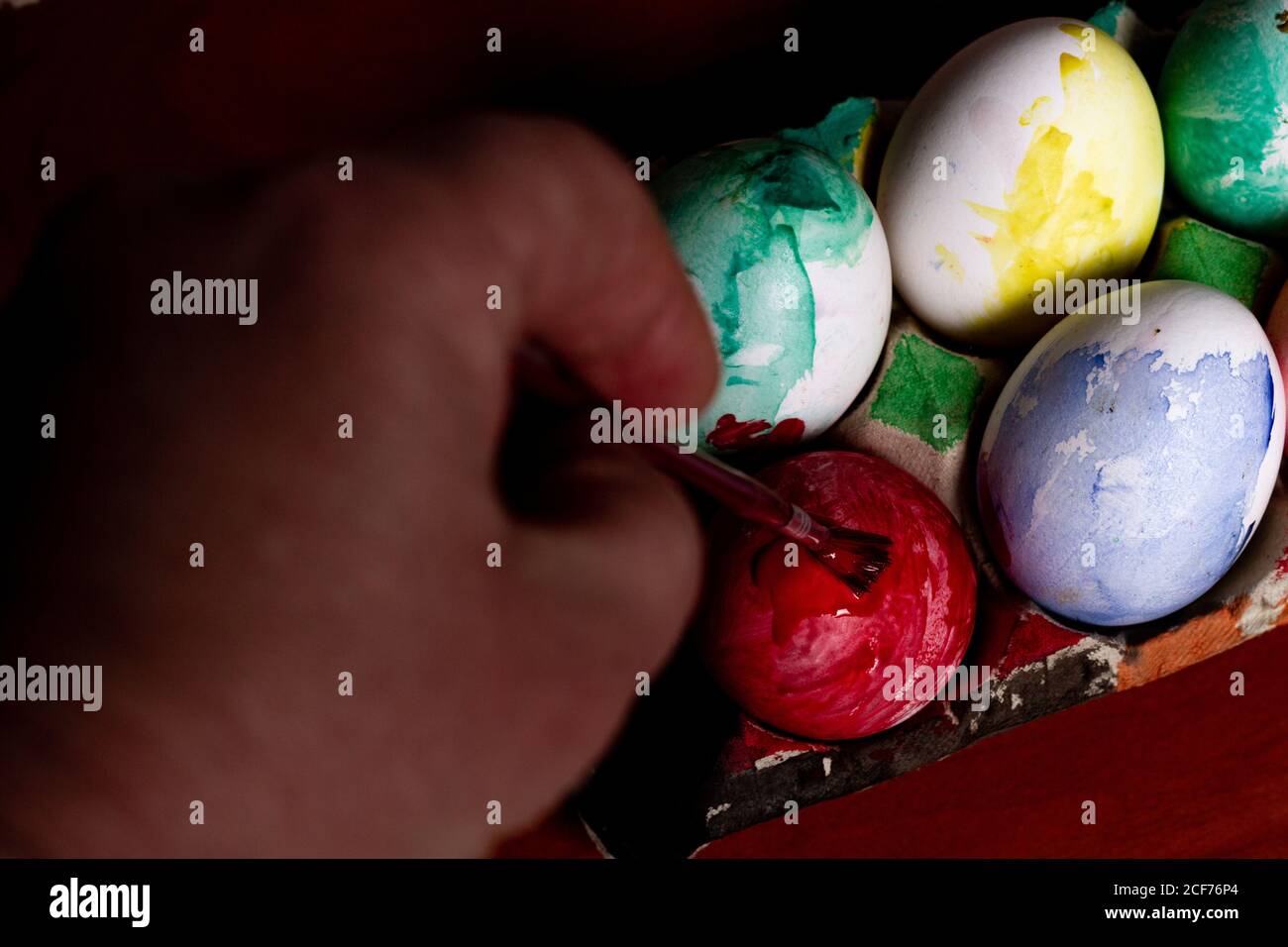 Crop hand painting Easter eggs Stock Photo