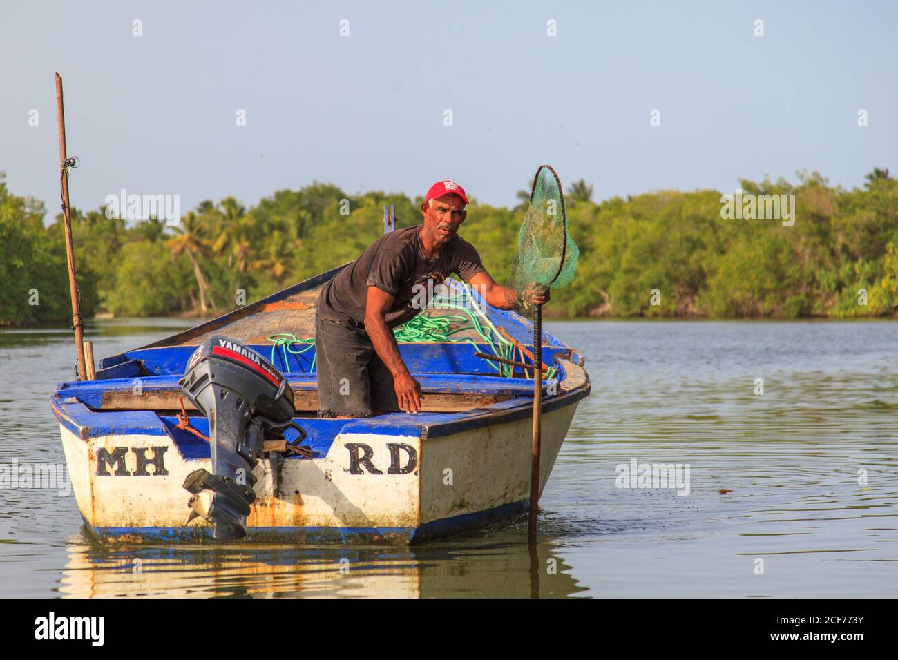 Miches, El Seibo, Dominican Republic - May 23, 2015: Fisherman on his way out to sea to fish in Miches, Dominican Republic. Stock Photo