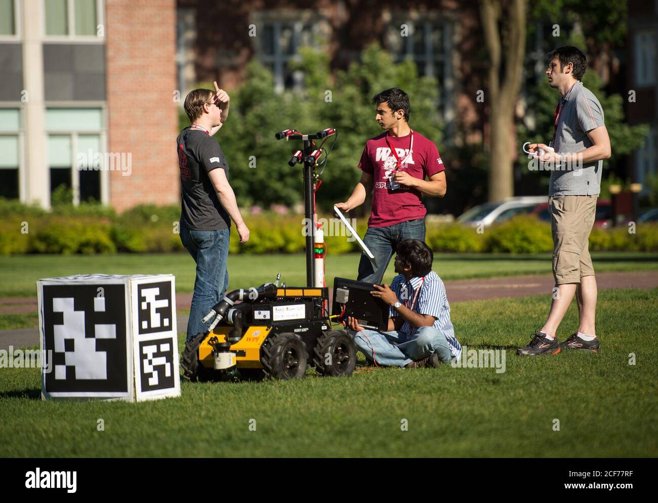 Members of the Worcester Polytechnic Institute (WPI) team AERO (Autonomous Exploration RObot) work on their robot in the practice field during the NASA 2013 Sample Return Robot Challenge, Tuesday, June 4, 2013, at the Worcester Polytechnic Institute (WPI) in Worcester, Mass. The AERO team is one of eleven teams competing for a $1.5 million NASA prize purse. Teams will be required to demonstrate autonomous robots that can locate and collect samples from a wide and varied terrain, operating without human control. The objective of this NASA-WPI Centennial Challenge is to encourage innovations in Stock Photo