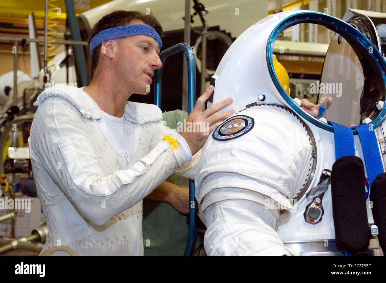 Astronaut C. Michael Foale prepares to don a Mark III advanced space suit technology demonstrator. Stock Photo