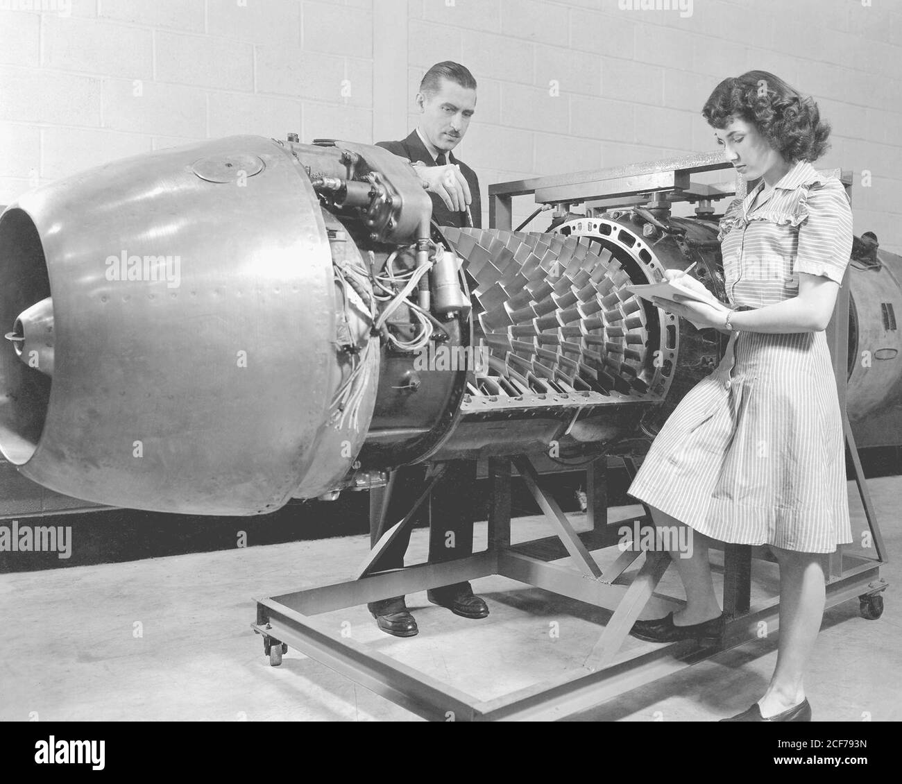 Exhibits for the Inspection by the Institute of Aeronautical Science Group-JUMO 004 Jet Propelled Engine with cover removed. Design variables and the arrangement of blades on the eight-stage axial flow compressor of a Junkers Jumo, 004, turbojet engine is shown being investigated at the Aircraft Engine Research Laboratory of the National Advisory Committee for Aeronautics, Cleveland, Ohio, now known as John H. Glenn Research Center at Lewis Field. Stock Photo