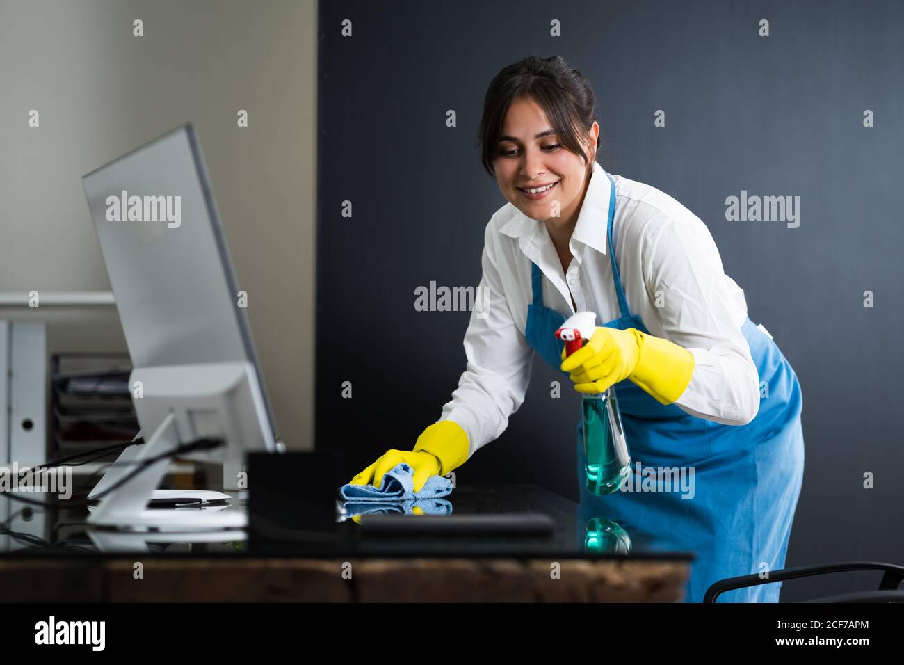 Janitor Cleaning Office Desk. Hygiene Cleaner Service Stock Photo