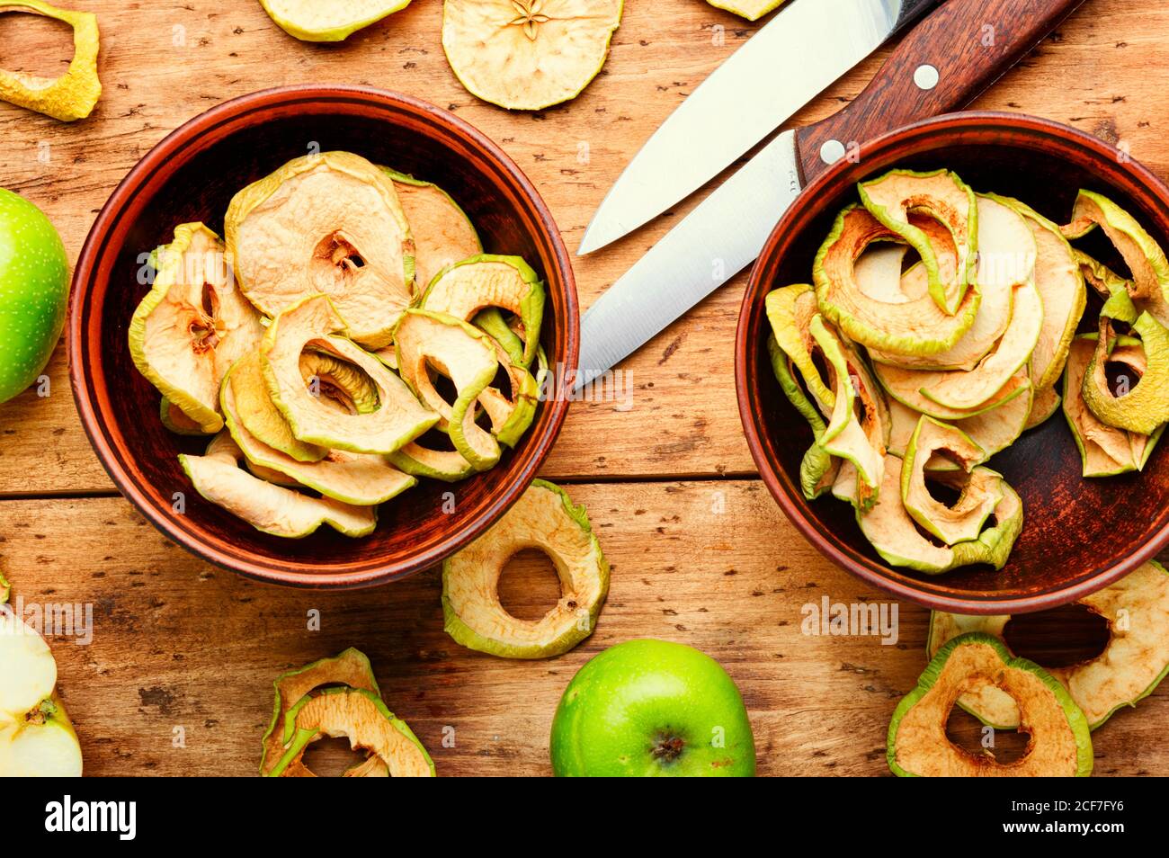 Apple chips on rustic wooden background.Dried apples Stock Photo