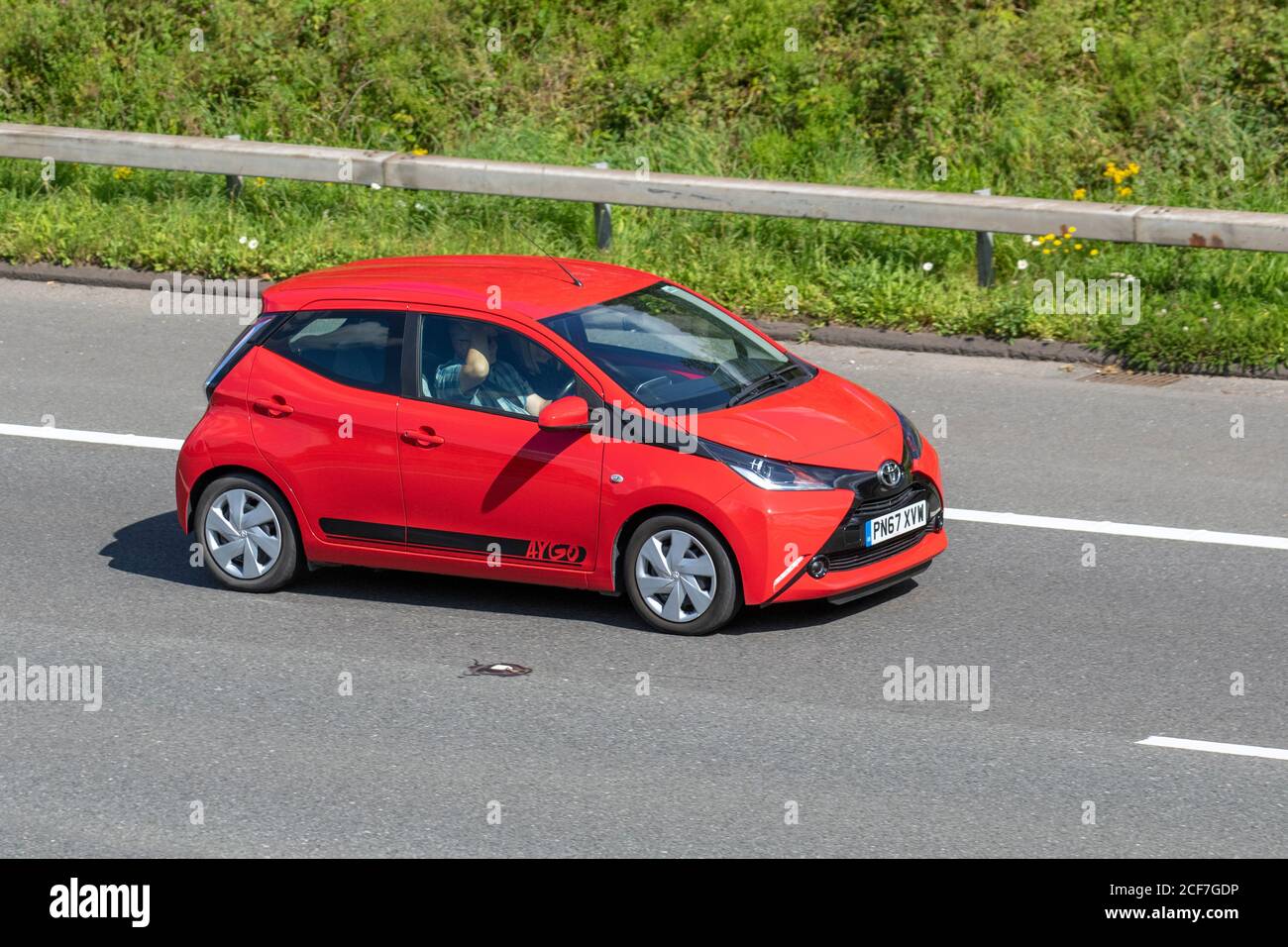 2017 red Toyota Aygo X-Play VVT-I; Vehicular traffic moving vehicles, cars driving vehicle on UK roads, motors, motoring on the M6 motorway highway network. Stock Photo