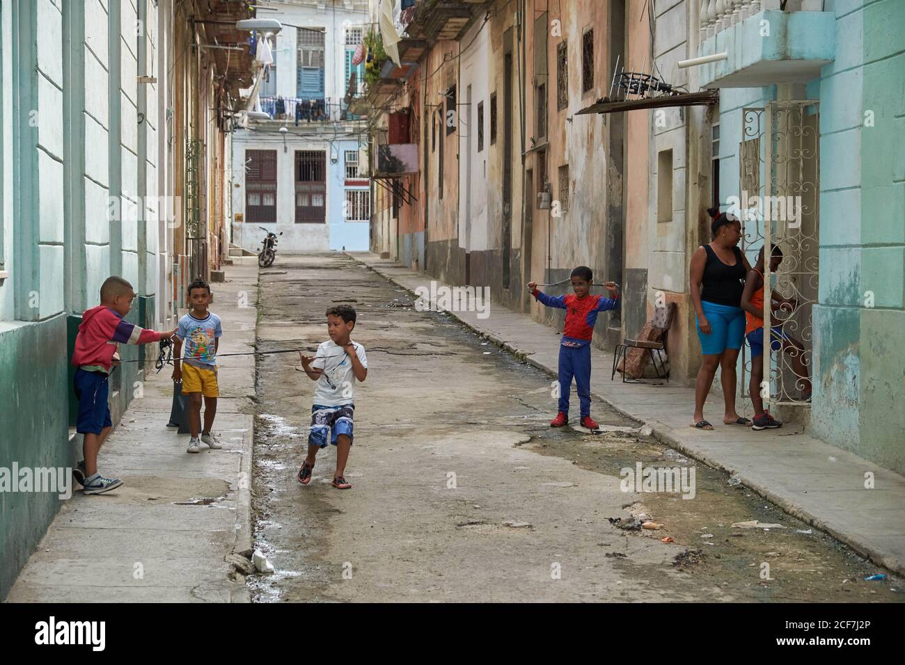 CUBA - DECEMBER 28, 2018: Little black boys having fun on narrow street between old buildings Stock Photo