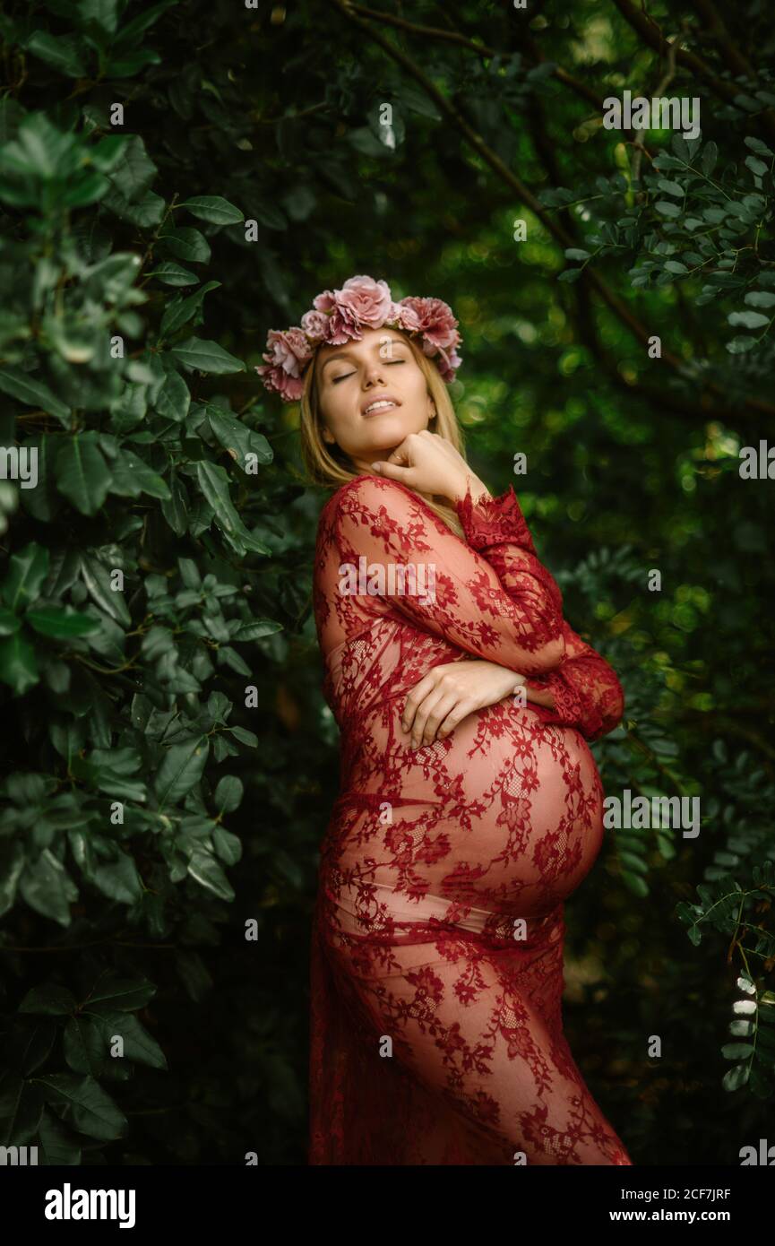Pregnant woman in red dress hi-res stock photography and images - Alamy