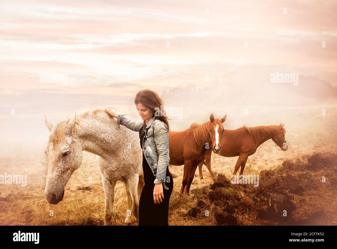 Beautiful scenery of a young Woman among horses in el hierro island, canary island spain Stock Photo