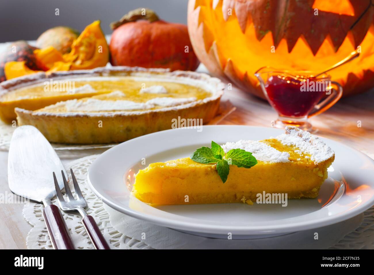 Piece of delicious homemade halloween pumpkin cake with leaf of mint. Food photography Stock Photo