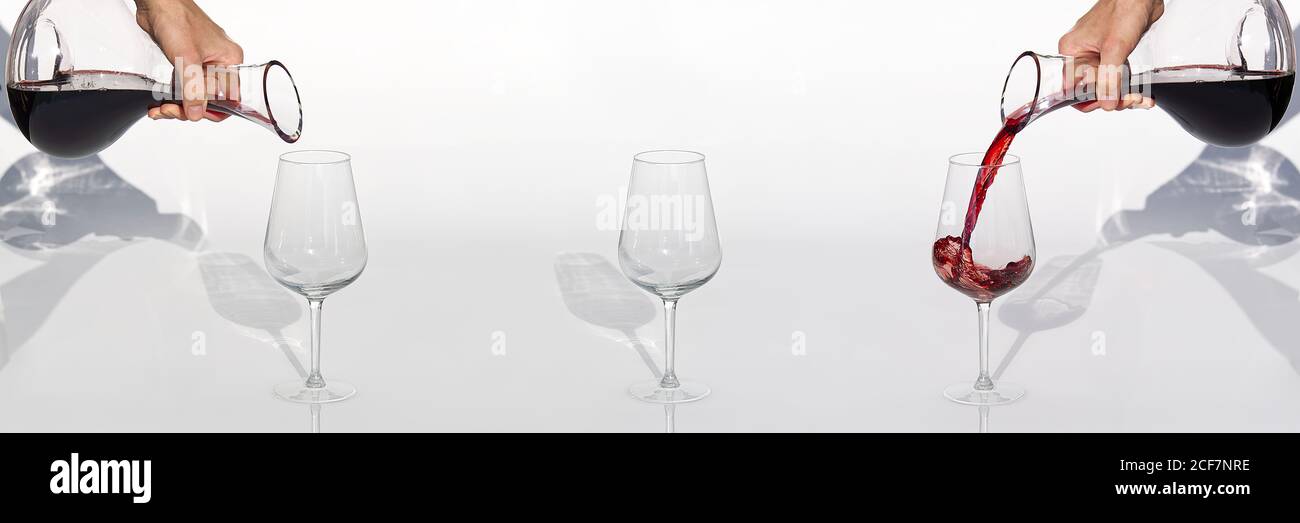https://c8.alamy.com/comp/2CF7NRE/sommelier-pours-red-wine-from-decanter-to-wineglass-on-white-background-panoramic-shoot-or-banner-2CF7NRE.jpg