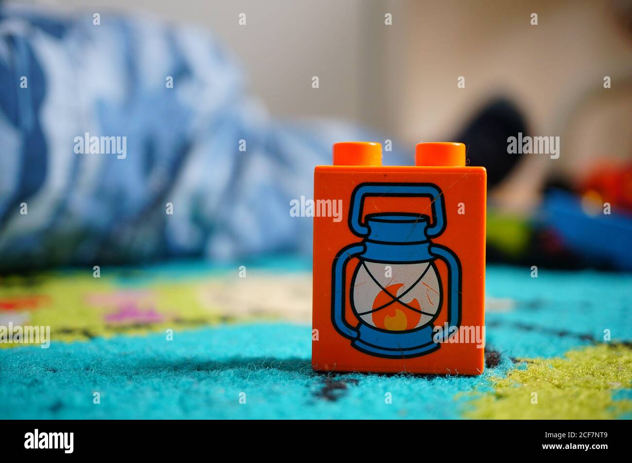 poznan-poland-sep-02-2020-plastic-orange-lego-duplo-block-with-oil