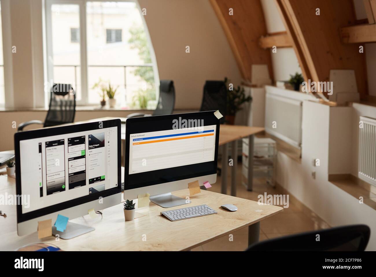 Image of computer monitors with software on the table at modern office Stock Photo