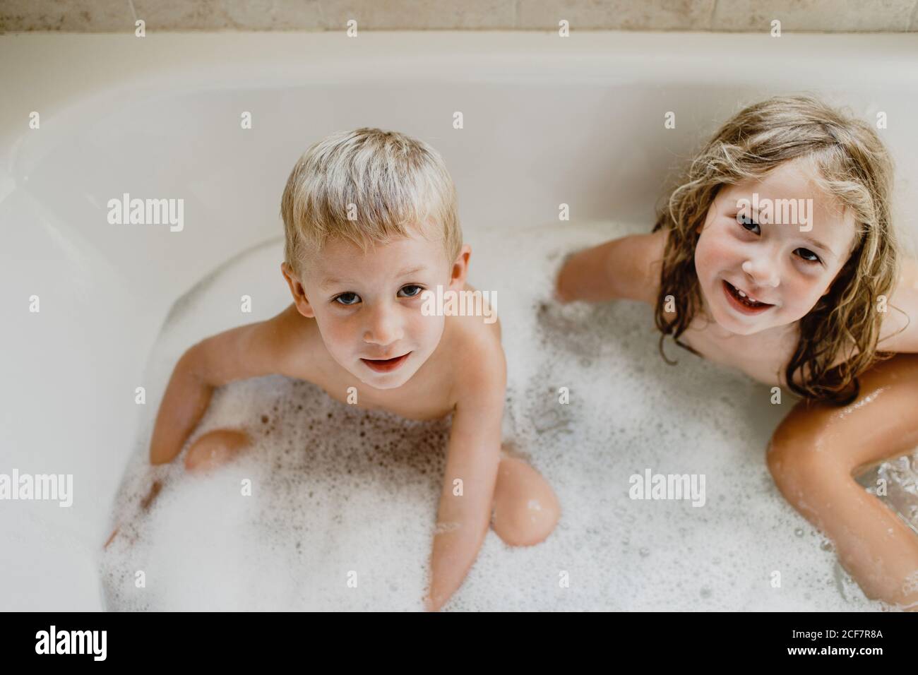 Funny children playing with foam in bath Stock Photo Alamy