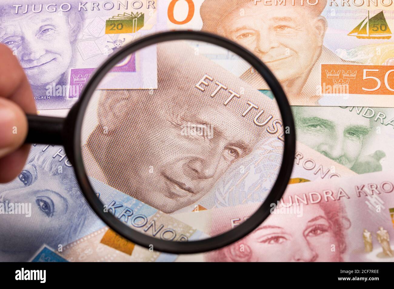 Swedish crowns in a magnifying glass a business background Stock Photo ...
