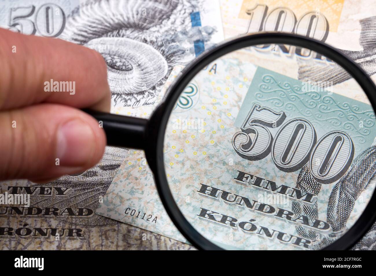 Money from the Faroe Islands in a magnifying glass a business background Stock Photo