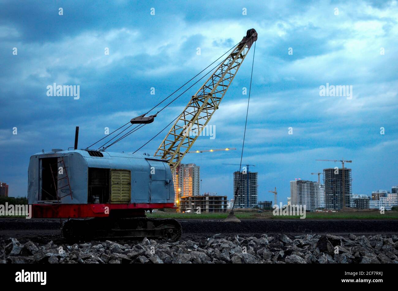 Large crawler crane or dragline excavator with a heavy metal wrecking ball on a steel cable. Wrecking balls at construction sites. Dismantling and dem Stock Photo