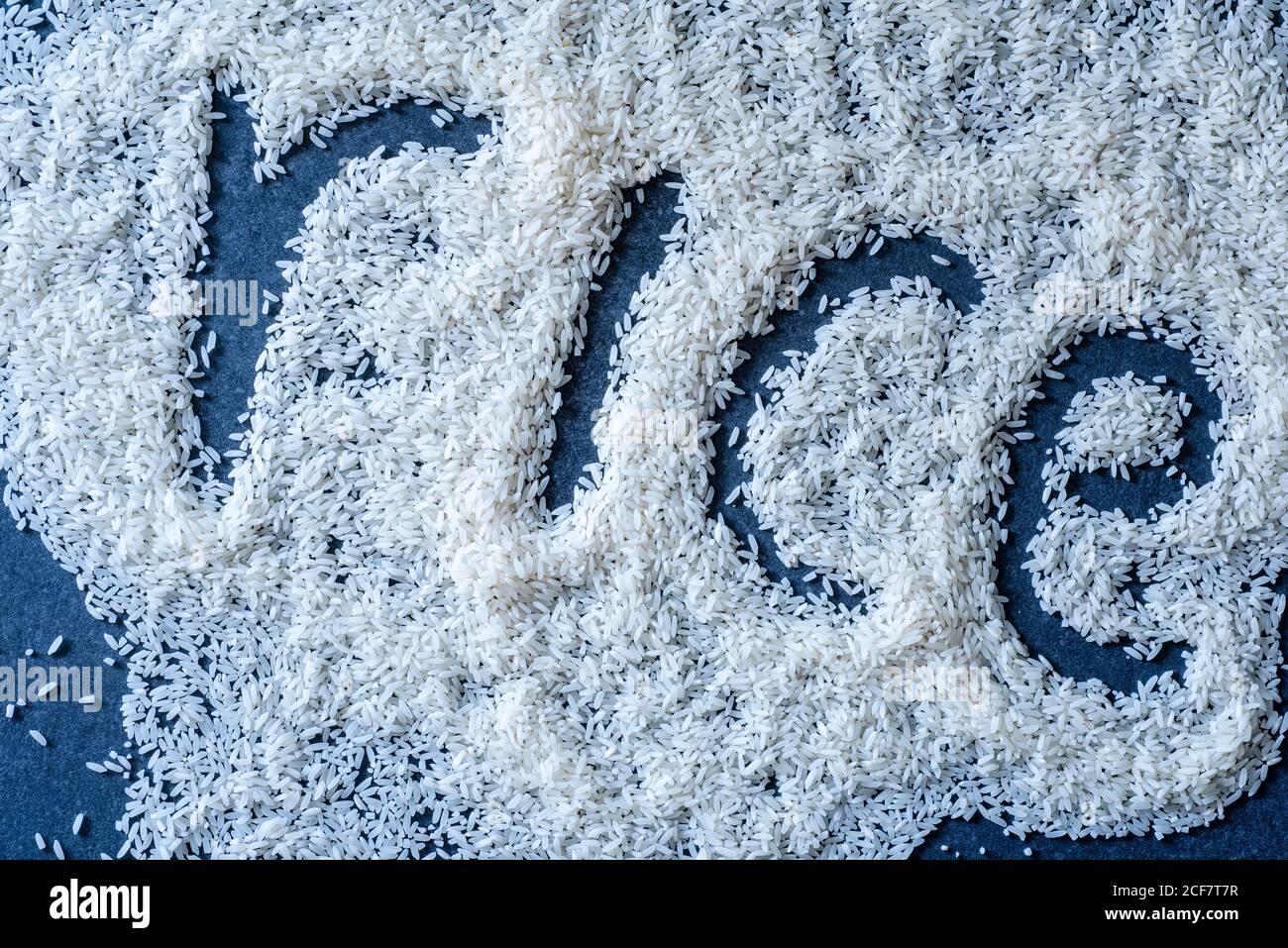 Word rice spelled out in rice grains, overhead view Stock Photo