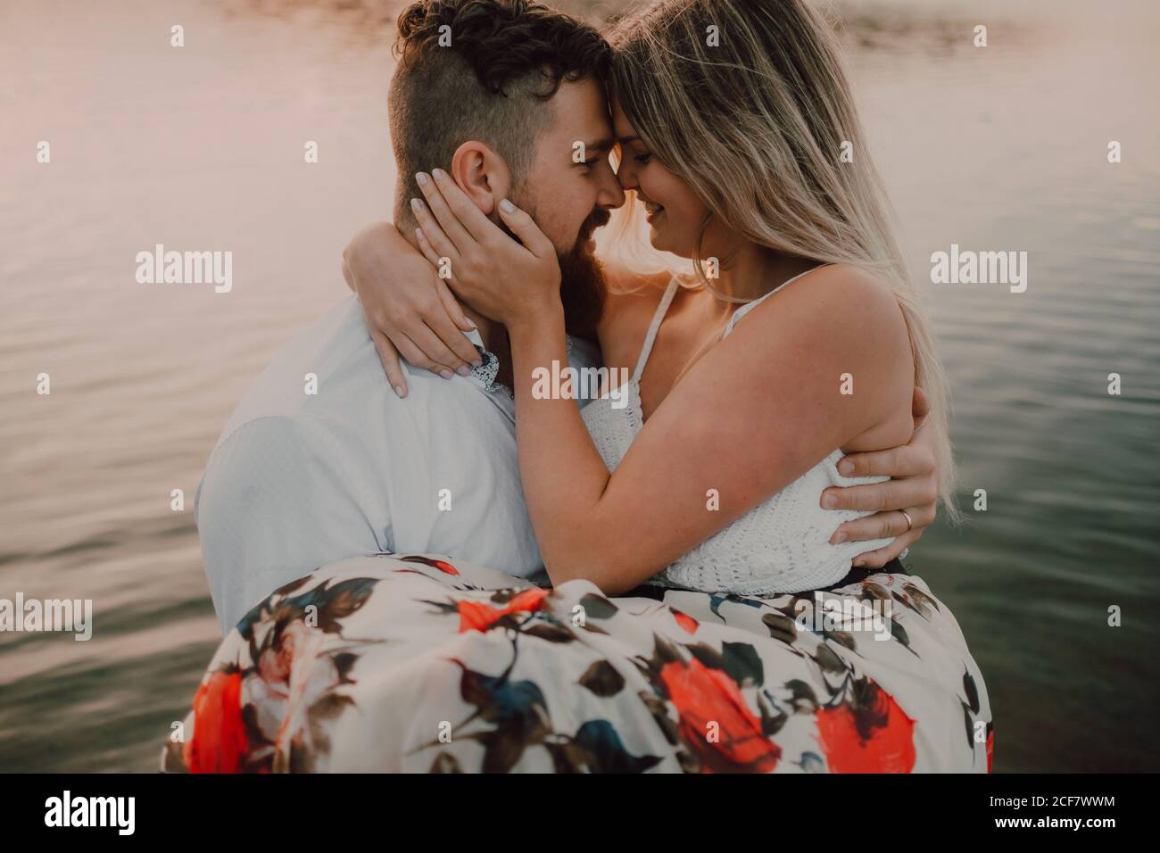 Bearded man holding a Woman in the lake Stock Photo - Alamy