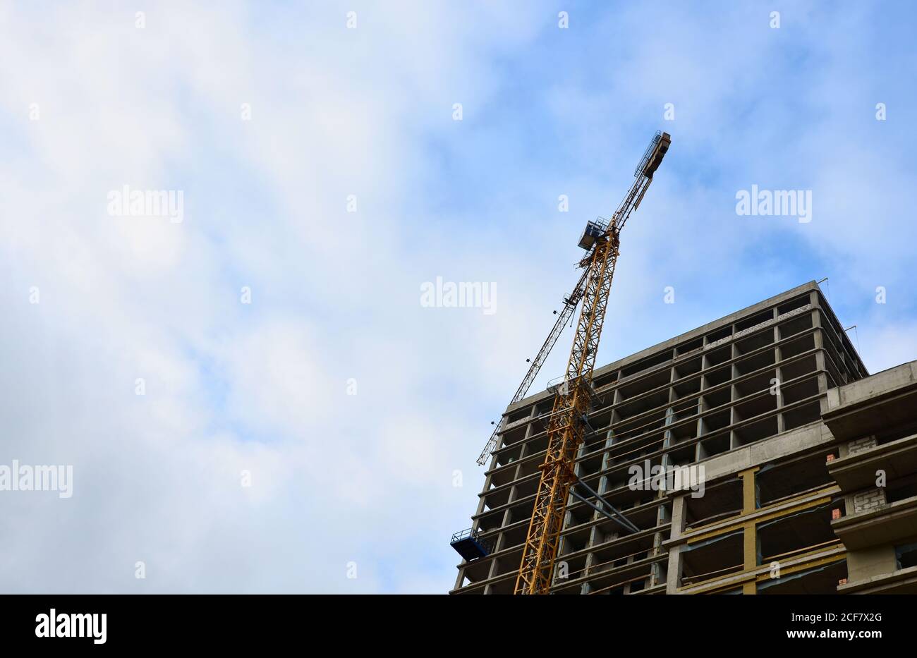 Tower cranes constructing a new building at construction site. Stock Photo