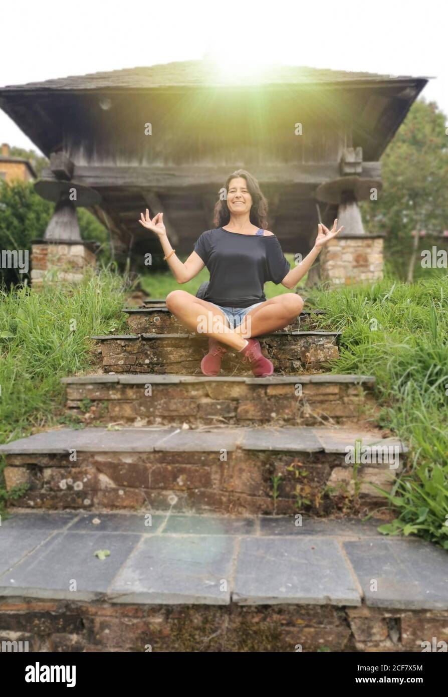 Woman practicing yoga. Padmasana pose. Relaxed gesture in a natural environment Stock Photo