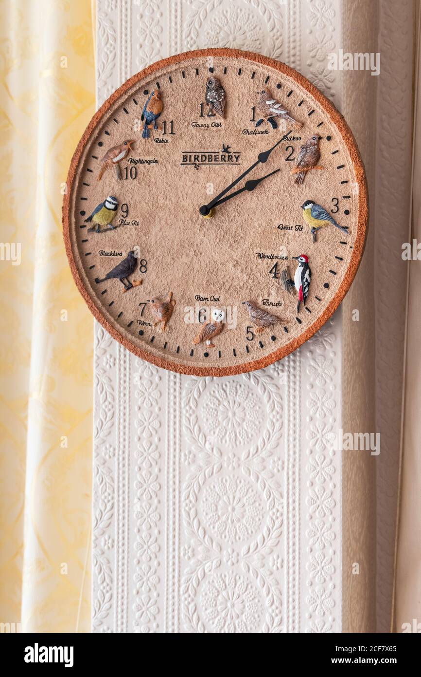 Decorative clock hanging in a home in the living room. Stock Photo