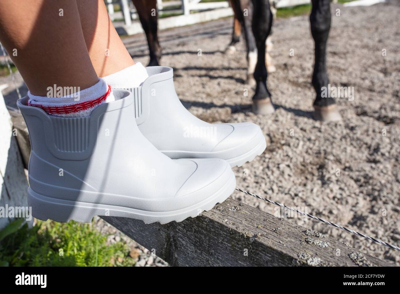 Legs girl wearing rubber boots hi-res stock photography and images - Alamy