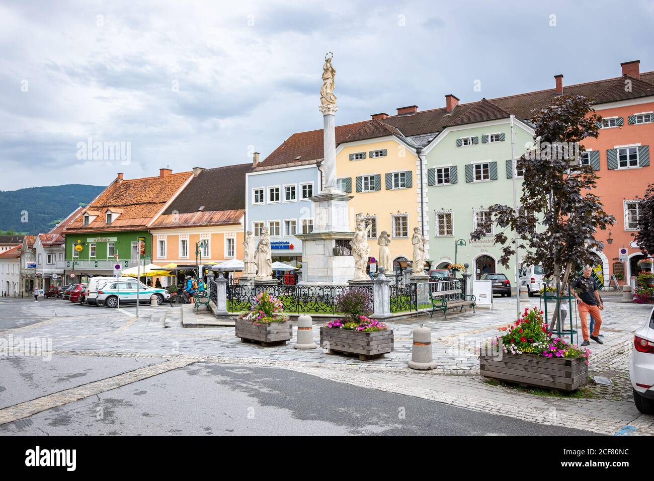 quare with statues in the centre of the town of Murau in state of Steiermark, Austria. Traditional central european buildings in light colors. Stock Photo