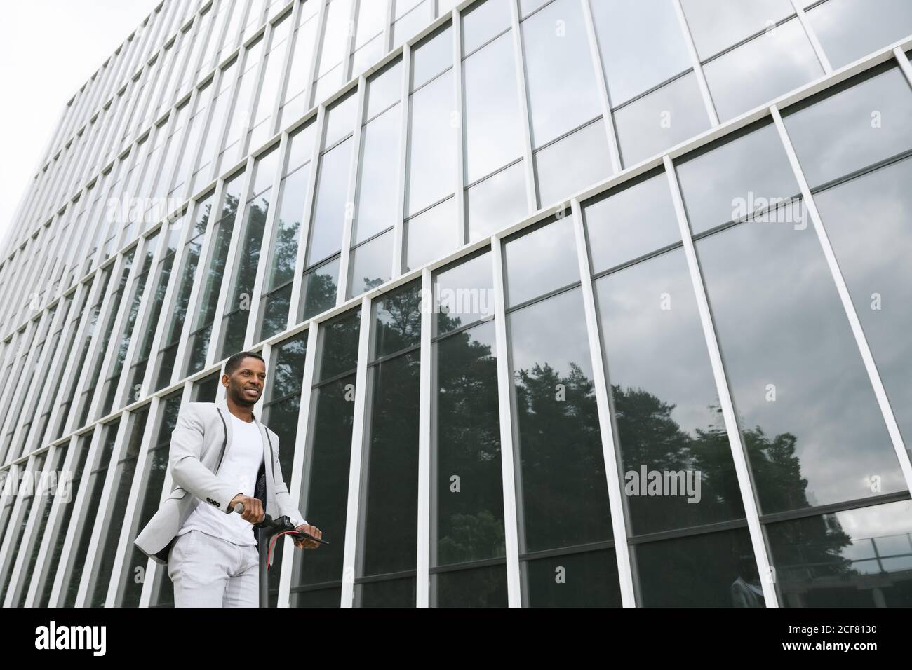 Man in suit on electric scooter hi-res stock photography and images - Alamy