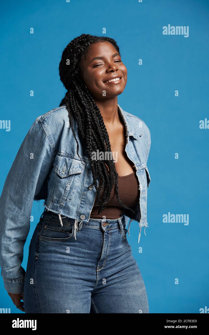 Positive beautiful African American Woman with braids in denim outfit ...