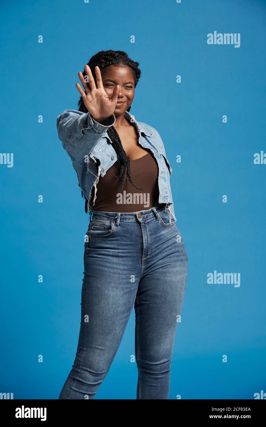 Positive beautiful African American Woman with braids in denim outfit ...