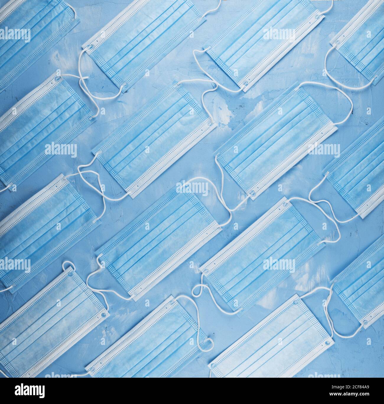 Medical masks on the blue colored background Stock Photo - Alamy