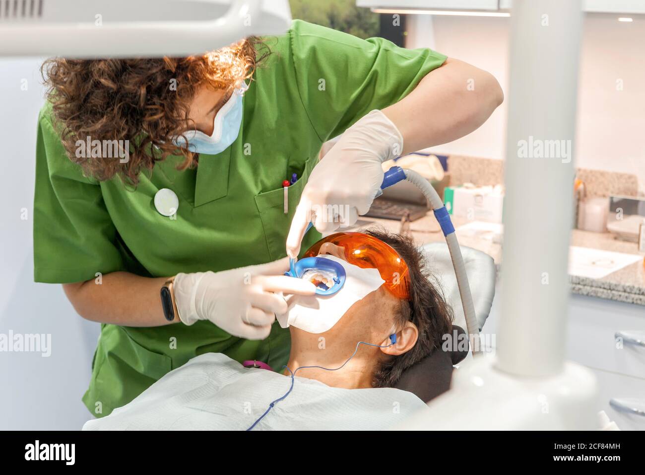 Dentist making teeth filling in mouth of patient Stock Photo - Alamy
