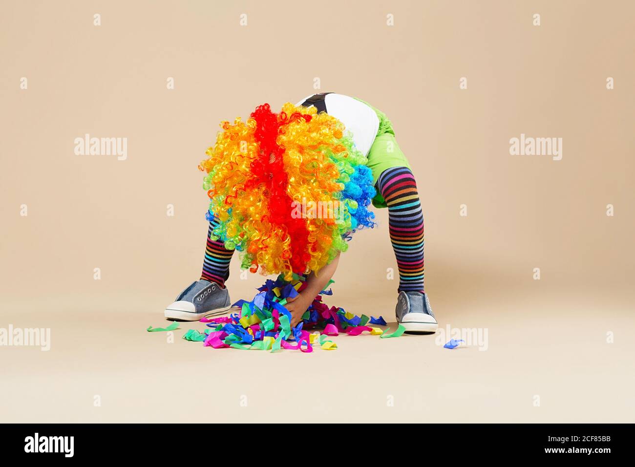 Happy clown boy with large colorful wig. Let's party! Funny kid clown. 1 April Fool's day concept. Portrait of a child throws up a multi-colored tinse Stock Photo - Alamy Happy clown boy with large colorful wig. Let's party! Funny kid clown. 1 April Fool's day concept. Portrait of a child throws up a multi-colored tinse Stock Photo - Alamy