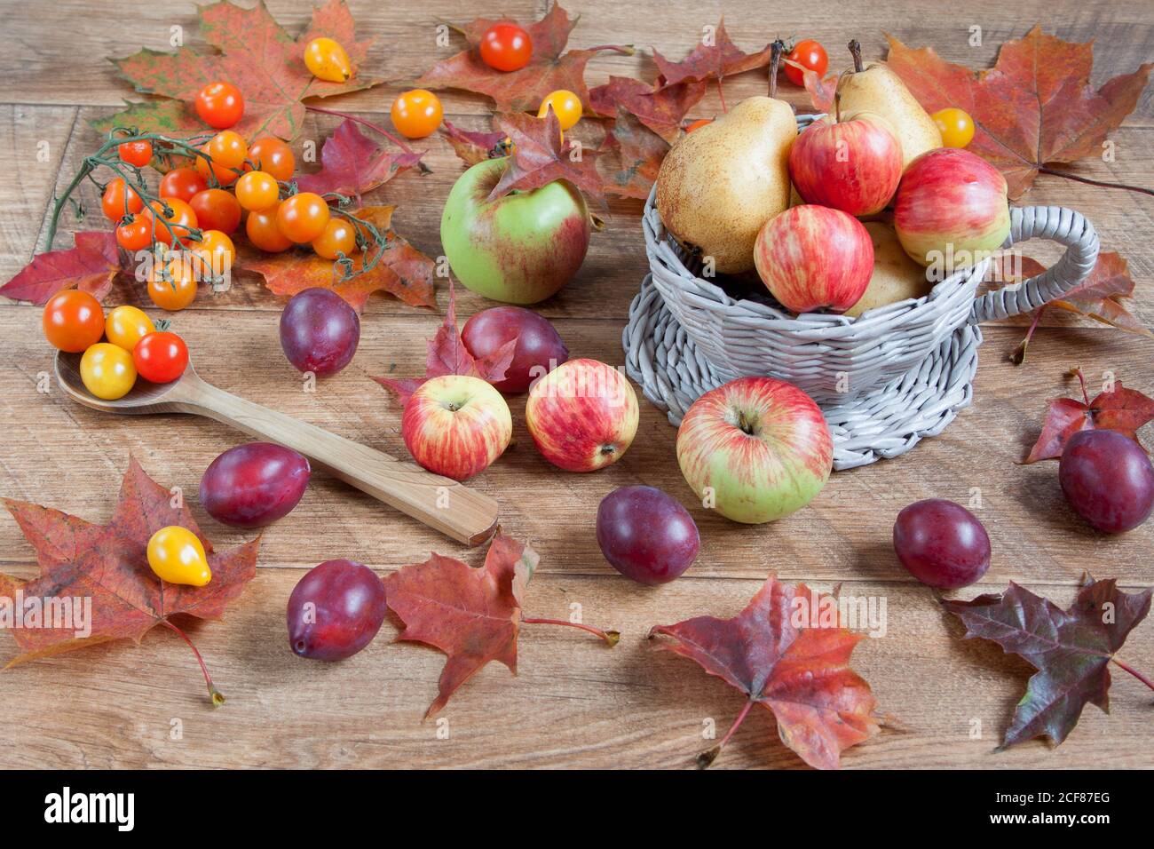 Autumn still life. Various fruits and vegetables is lying on wooden ...