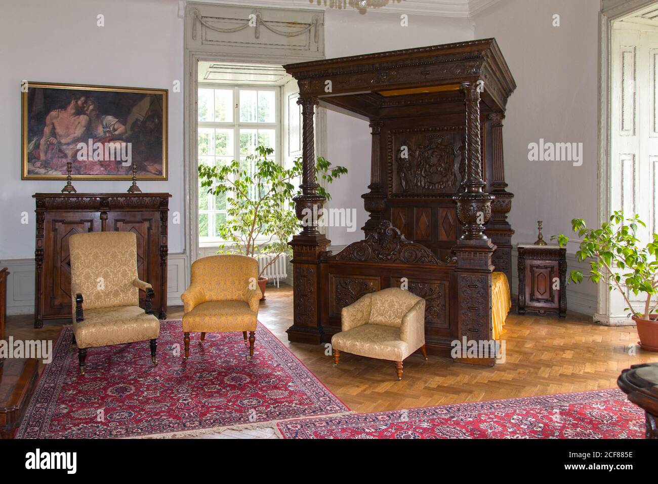 Wooden carved antique canopy bed with coat of arms in the Vihorlát Museum. Stock Photo