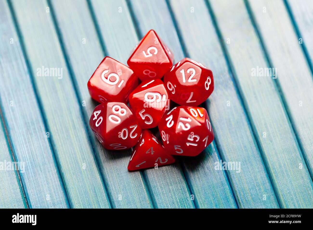 Lots of simple red RPG game dice, polyhedral dice set for role playing games and scenarios, top view. Dices group closeup. Tabletop board games Stock Photo