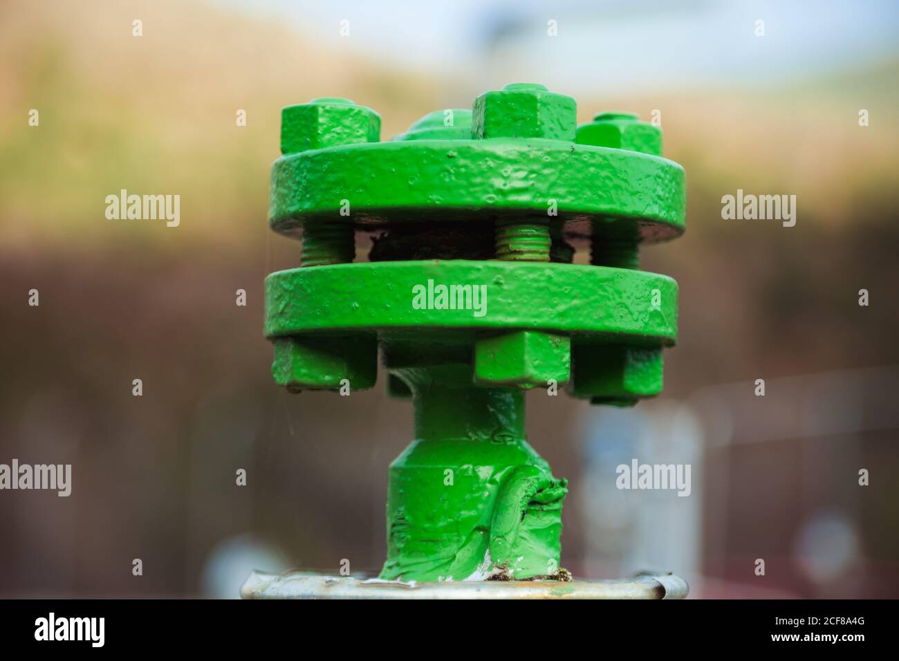 Closeup of steel joint connecting flanges with bolts and nuts on pipe transferring liquids at factory Stock Photo