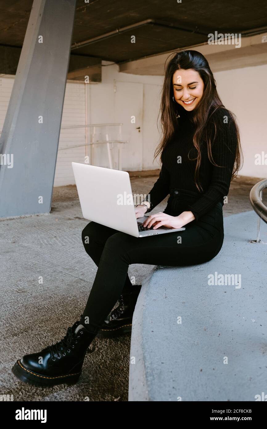 Female freelancer using laptop in courtyard Stock Photo